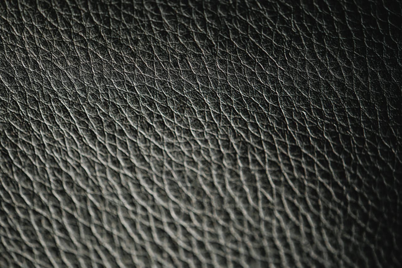 Macro photograph showcasing the intricate texture and pattern of black leather.